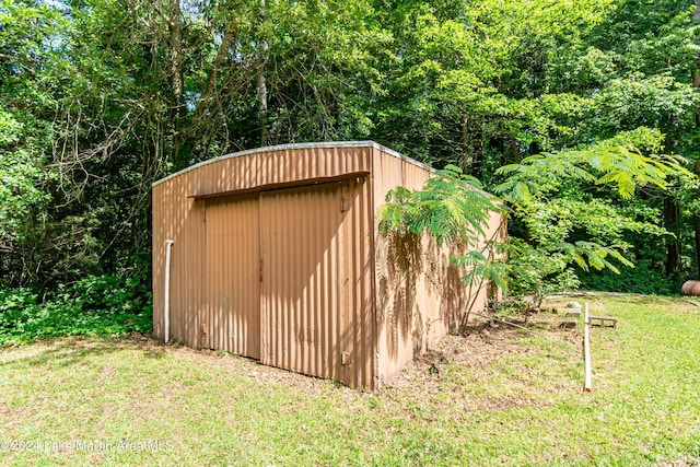 view of outdoor structure with a lawn