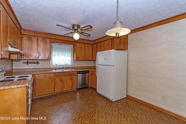 kitchen featuring pendant lighting, dark parquet flooring, white appliances, sink, and ceiling fan