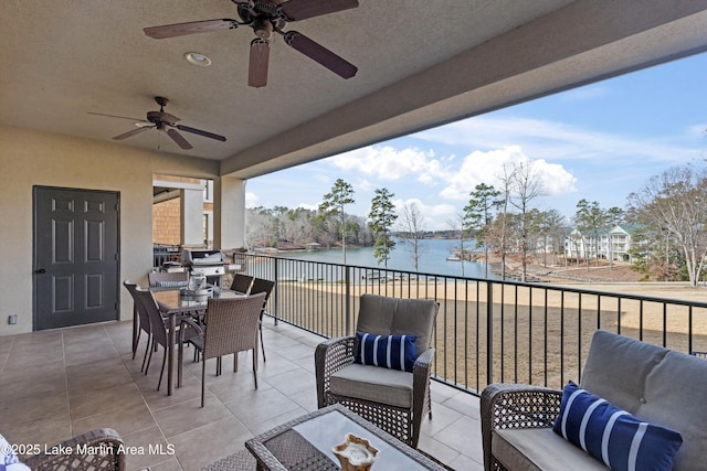 exterior space featuring an outdoor living space, ceiling fan, and a water view