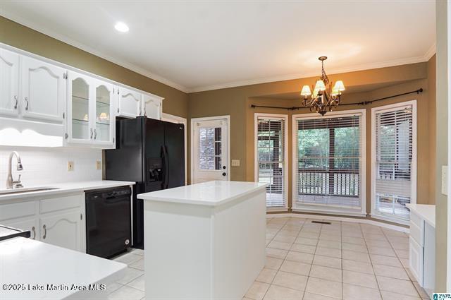 4376 Heritage View Rd, Birmingham, AL 35242 - kitchen featuring white cabinets, ornamental molding, a notable chandelier, and black appliances