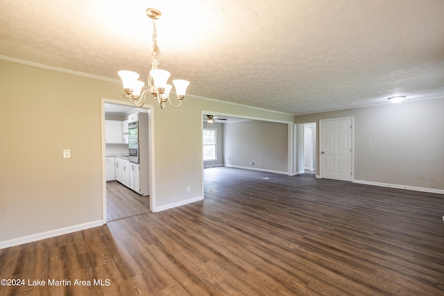 spare room featuring a textured ceiling, dark hardwood / wood-style floors, crown molding, and ceiling fan with notable chandelier