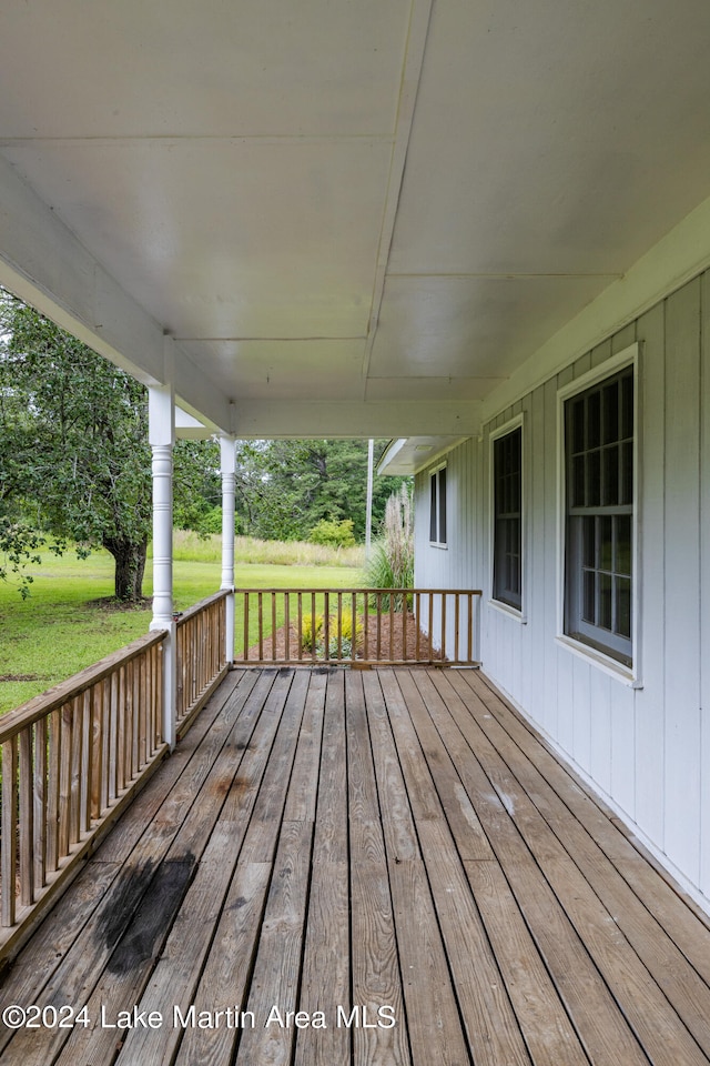 wooden terrace with a lawn