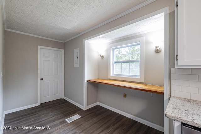 interior space featuring electric panel, dark hardwood / wood-style flooring, a textured ceiling, and ornamental molding