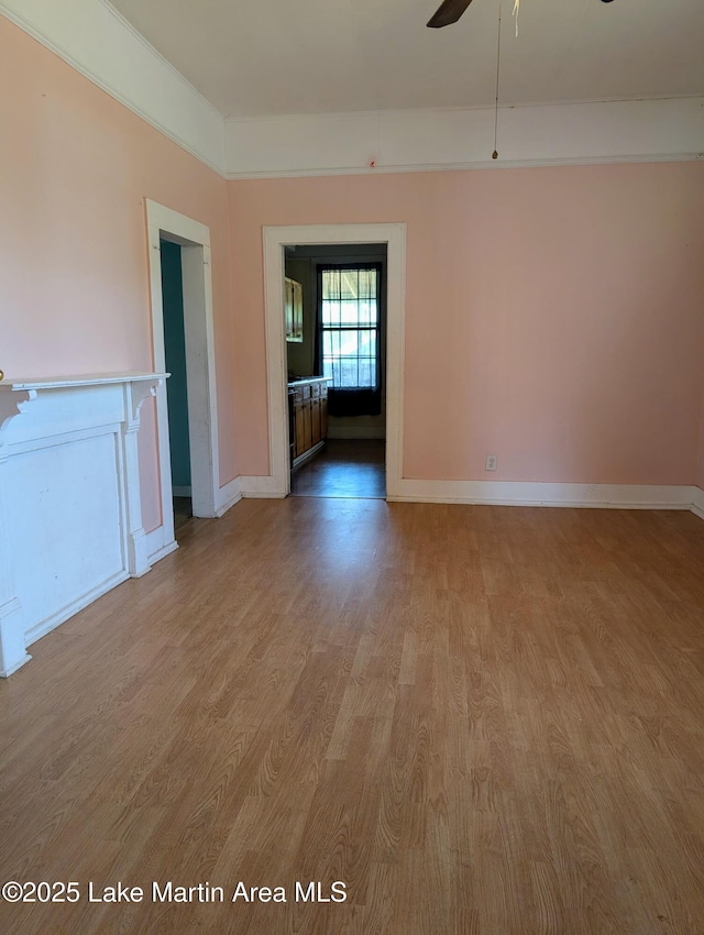 311 John St, Tallassee, AL 36078 - spare room featuring light wood-style floors, baseboards, and a ceiling fan