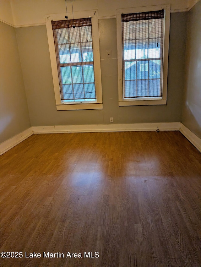 311 John St, Tallassee, AL 36078 - spare room with baseboards and wood finished floors