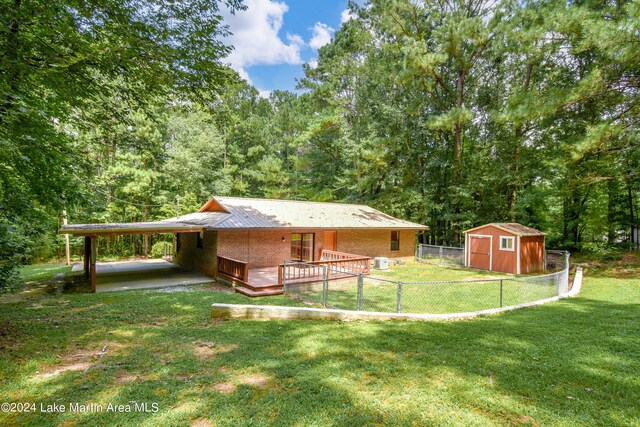 view of yard featuring a shed and a carport