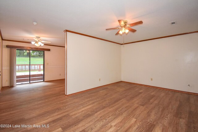 empty room featuring wood-type flooring, ceiling fan, and crown molding