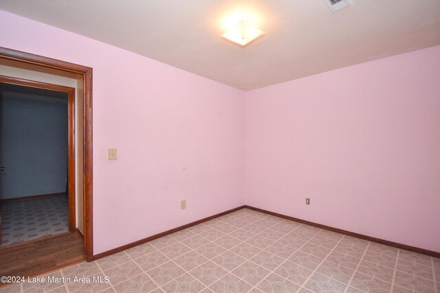 spare room featuring light hardwood / wood-style flooring