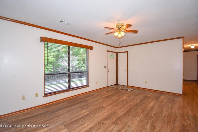 empty room with hardwood / wood-style flooring, ceiling fan, and ornamental molding