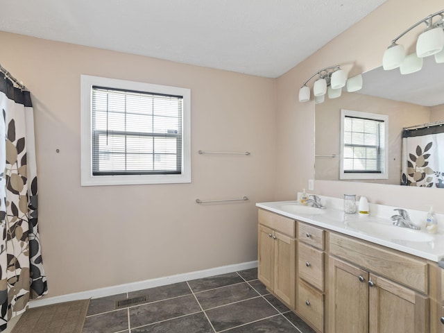 bathroom with vanity, tile patterned floors, and walk in shower