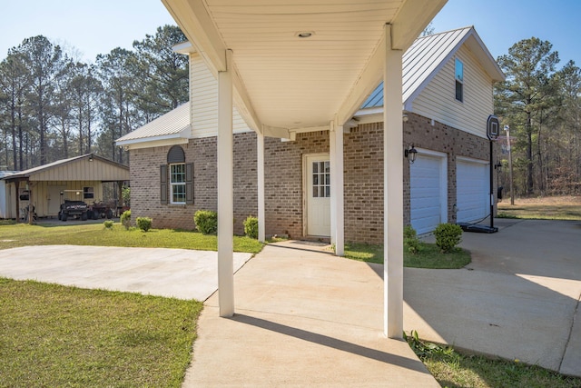 exterior space with a carport, a garage, and a front yard