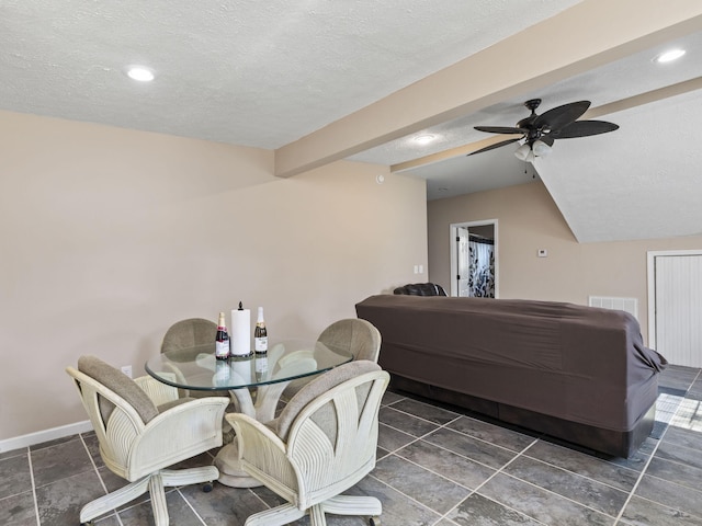 dining space with vaulted ceiling with beams, a textured ceiling, and ceiling fan