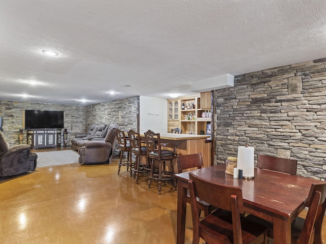 dining space with a textured ceiling