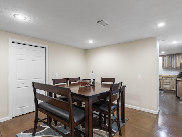 dining space featuring a textured ceiling