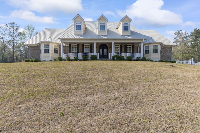 new england style home with a front yard and a porch