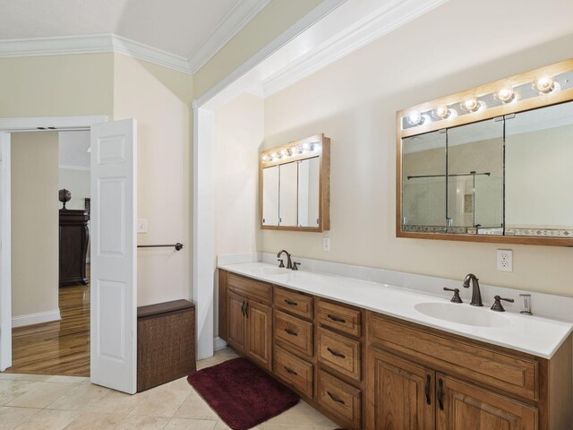 bathroom with tile patterned floors, vanity, and crown molding