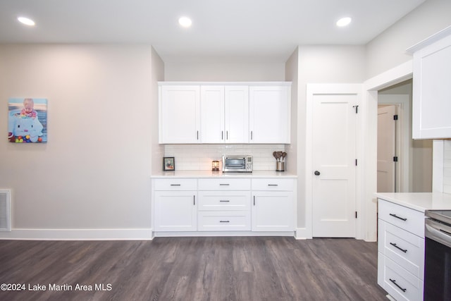 kitchen with white cabinets, backsplash, and dark hardwood / wood-style floors