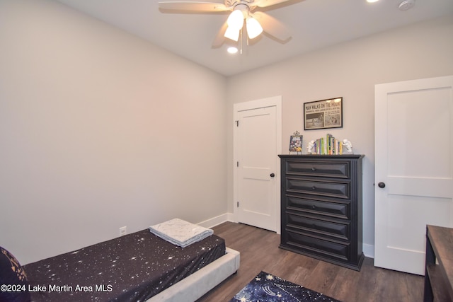 bedroom with ceiling fan and dark wood-type flooring