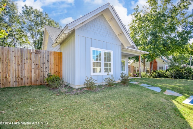 view of side of home featuring a yard