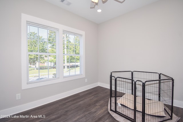 unfurnished room with ceiling fan and dark hardwood / wood-style floors