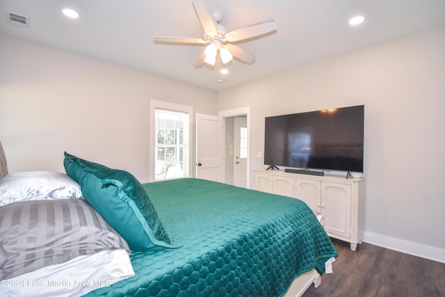 bedroom with ceiling fan and dark wood-type flooring