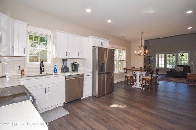 kitchen featuring sink, dark hardwood / wood-style flooring, white cabinetry, and stainless steel appliances