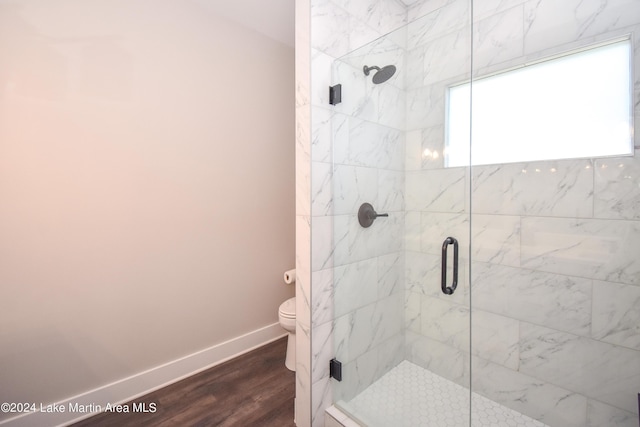 bathroom featuring hardwood / wood-style floors, toilet, and walk in shower