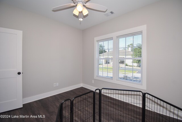 unfurnished bedroom featuring ceiling fan and dark hardwood / wood-style flooring