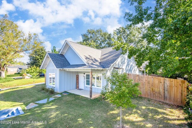 view of front of house with a front lawn and a patio