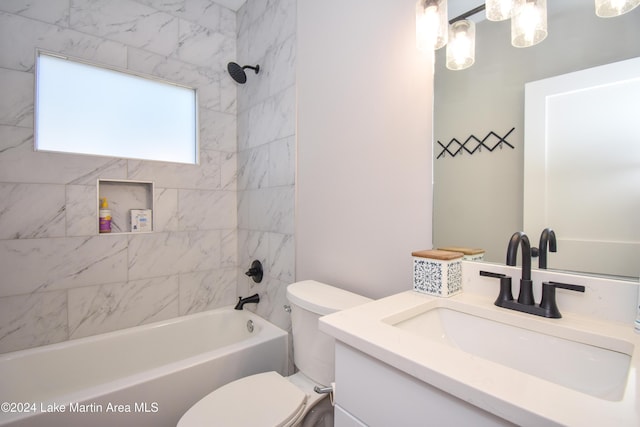 full bathroom with vanity, toilet, and tiled shower / bath