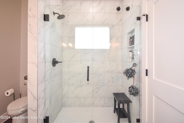 bathroom featuring an enclosed shower and toilet