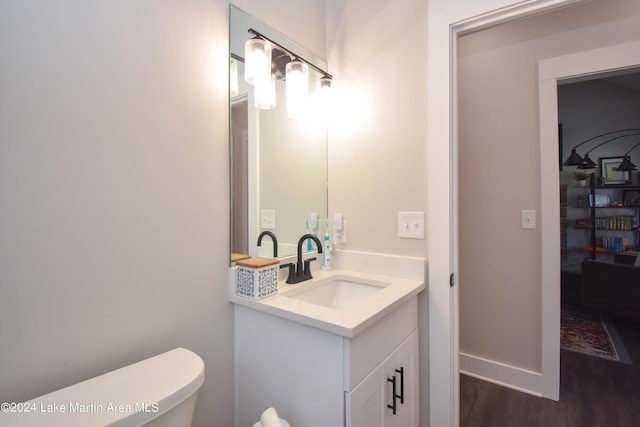 bathroom featuring vanity, toilet, and wood-type flooring