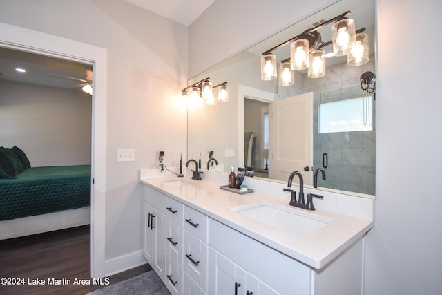 bathroom with hardwood / wood-style floors, ceiling fan, a shower with shower door, and vanity