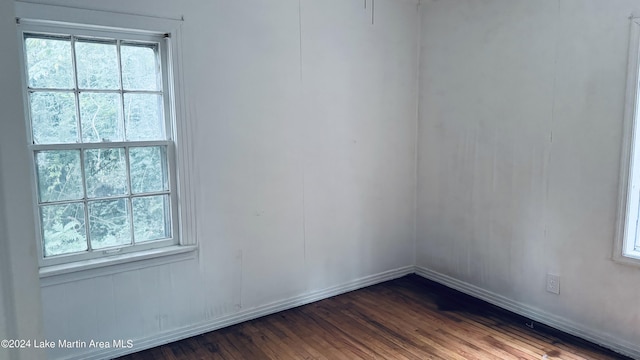 unfurnished room featuring dark hardwood / wood-style flooring