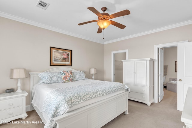 bedroom with light carpet, visible vents, a walk in closet, and ornamental molding