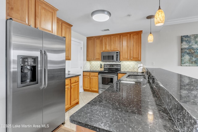 kitchen with light tile patterned floors, tasteful backsplash, visible vents, stainless steel appliances, and a sink