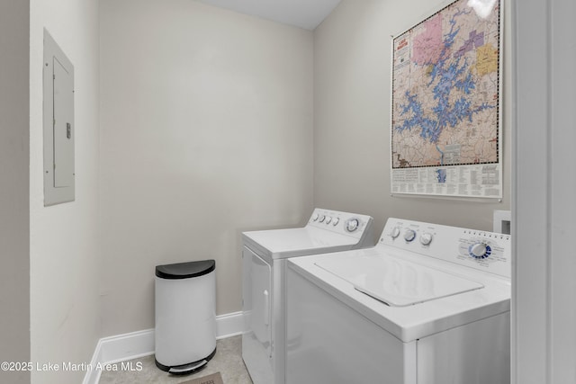 clothes washing area with laundry area, electric panel, baseboards, and separate washer and dryer