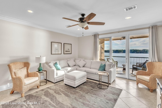 living area with a water view, light tile patterned flooring, visible vents, and ornamental molding