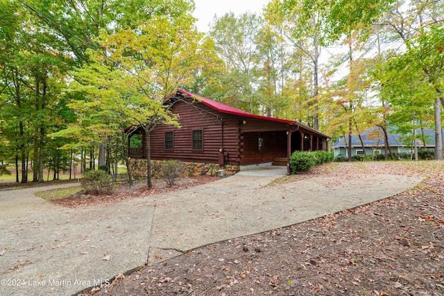 view of side of property featuring a carport