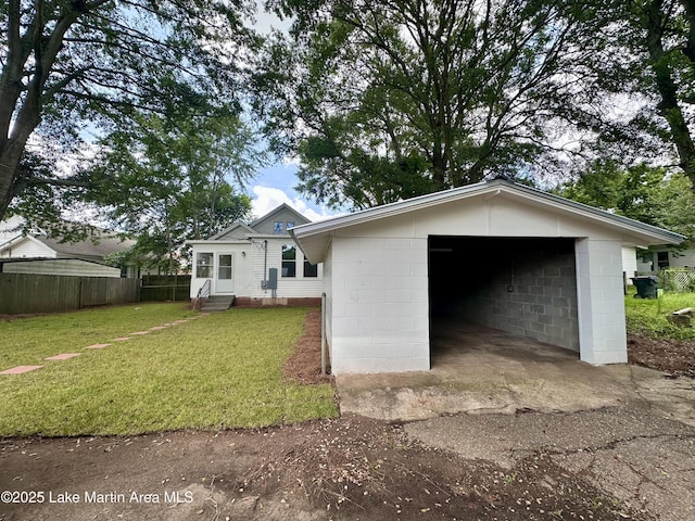 104 Central Blvd, East Tallassee, AL 36078 - view of front of house with concrete block siding, a garage, entry steps, and driveway