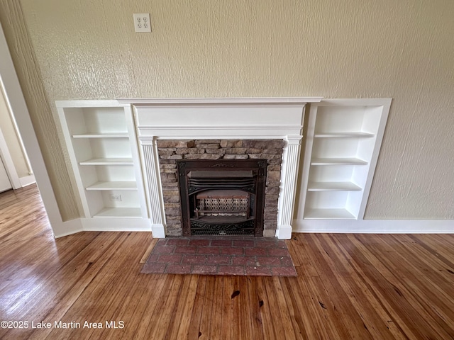 104 Central Blvd, East Tallassee, AL 36078 - detailed view of a stone fireplace, built in features, and wood finished floors
