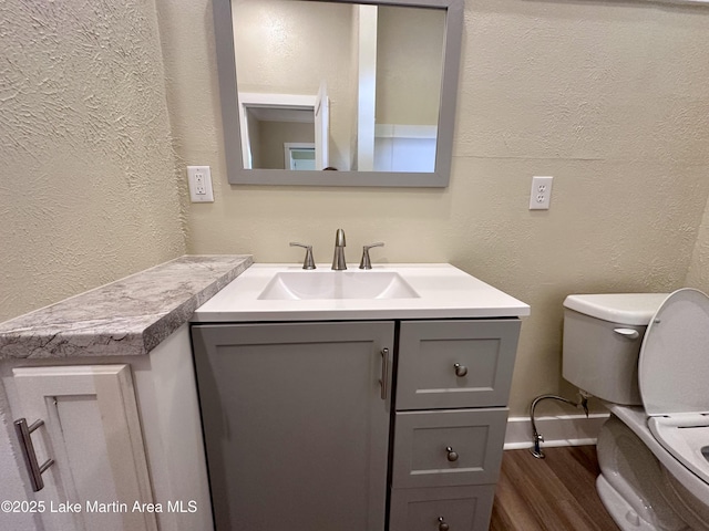 104 Central Blvd, East Tallassee, AL 36078 - half bath featuring a textured wall, vanity, and wood finished floors