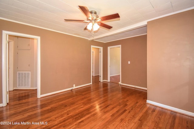 spare room featuring wood-type flooring, ceiling fan, and crown molding