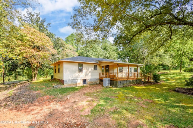 view of front of property featuring central AC unit, a front lawn, and a deck