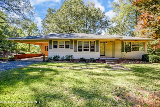 single story home with a front yard and a carport