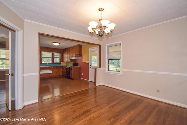 interior space featuring a chandelier, crown molding, and dark wood-type flooring