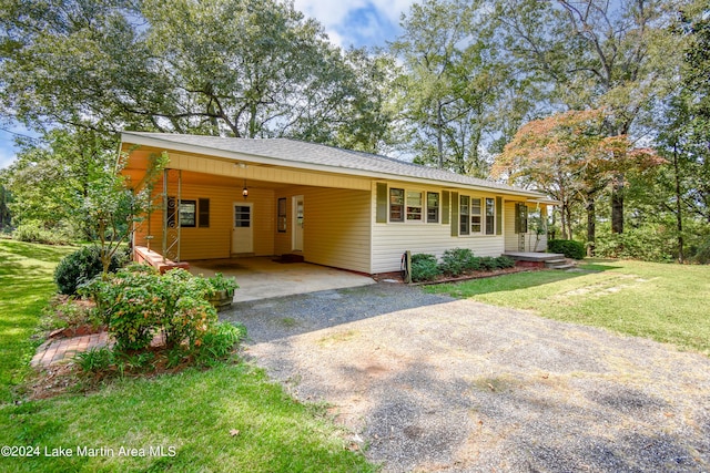 single story home featuring a carport and a front yard