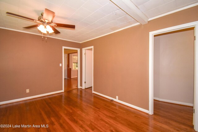 spare room with beamed ceiling, wood-type flooring, ceiling fan, and crown molding