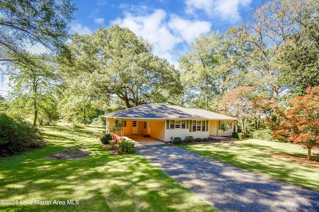 ranch-style house with a front lawn and a carport