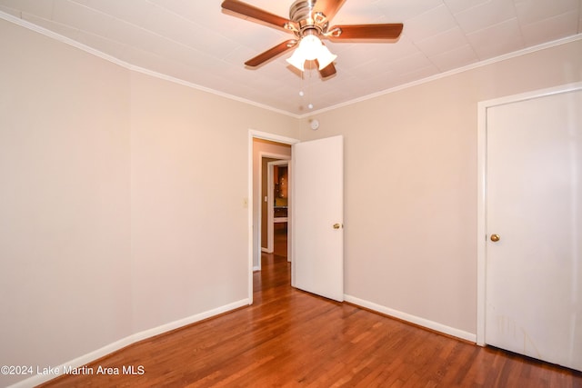 unfurnished room featuring hardwood / wood-style floors, ceiling fan, and crown molding